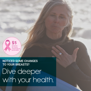 Woman in a wetsuit holding her hand over her chest as she holds a surfboard with writing overlay for breast cancer awareness month