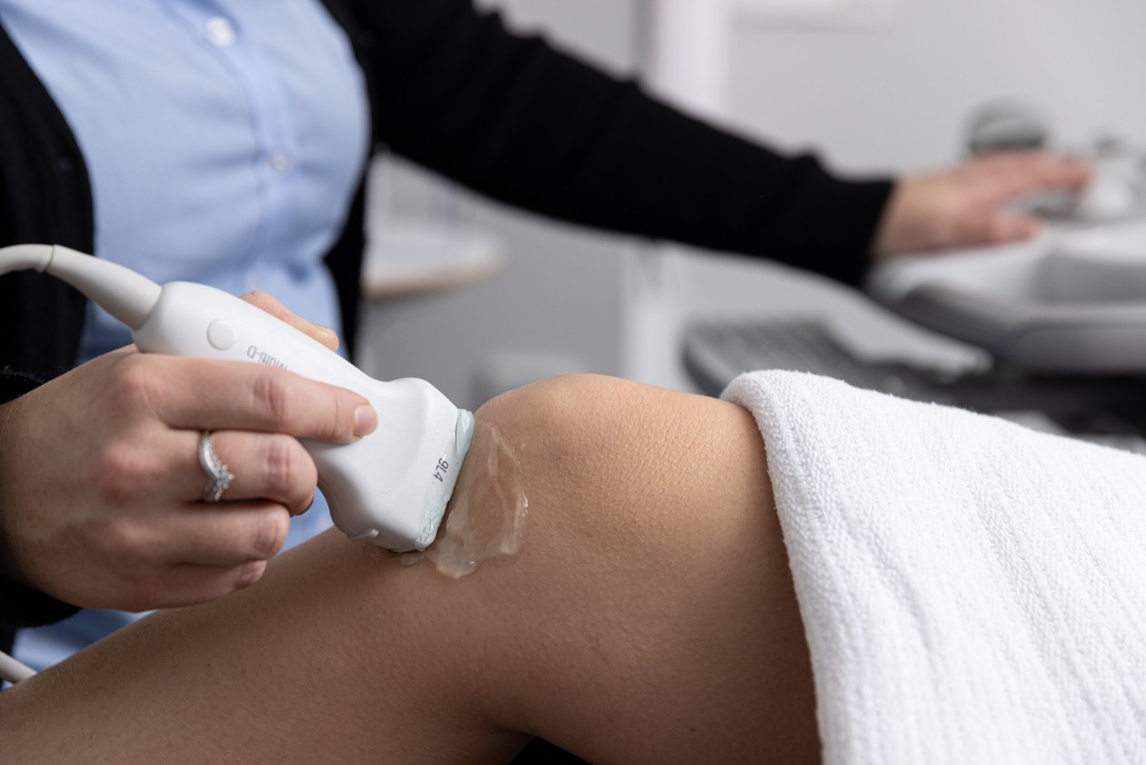 Radiographer using ultrasound probe to do a knee scan at Sunshine Coast Radiology