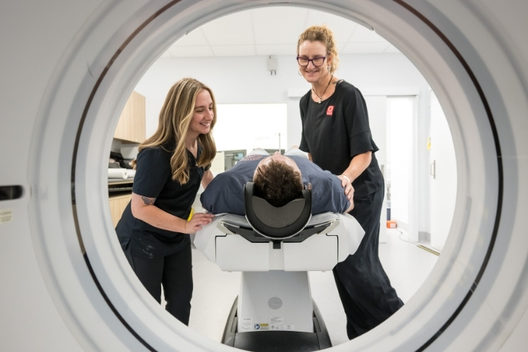 Two CT Radiographers support patient entering CT scan at Sunshine Coast Radiology.